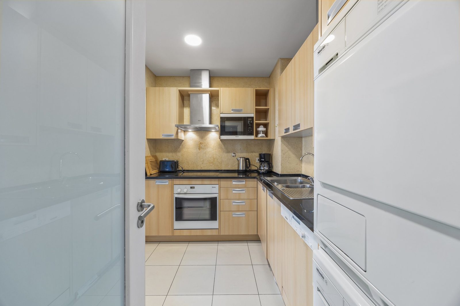 Kitchen with hood, microwave, and cabinets