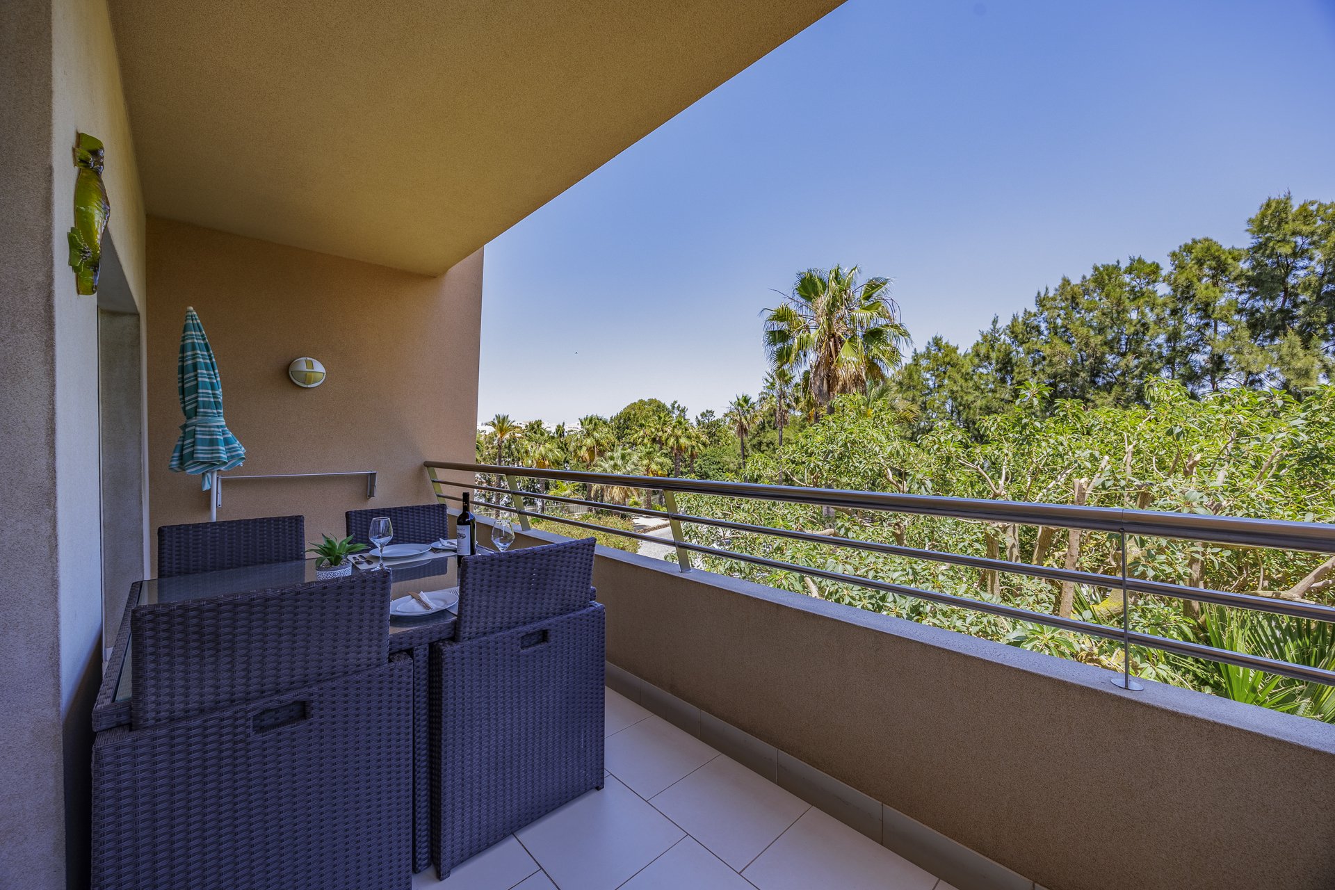Balcony seating area with a decorative seahorse and treed view