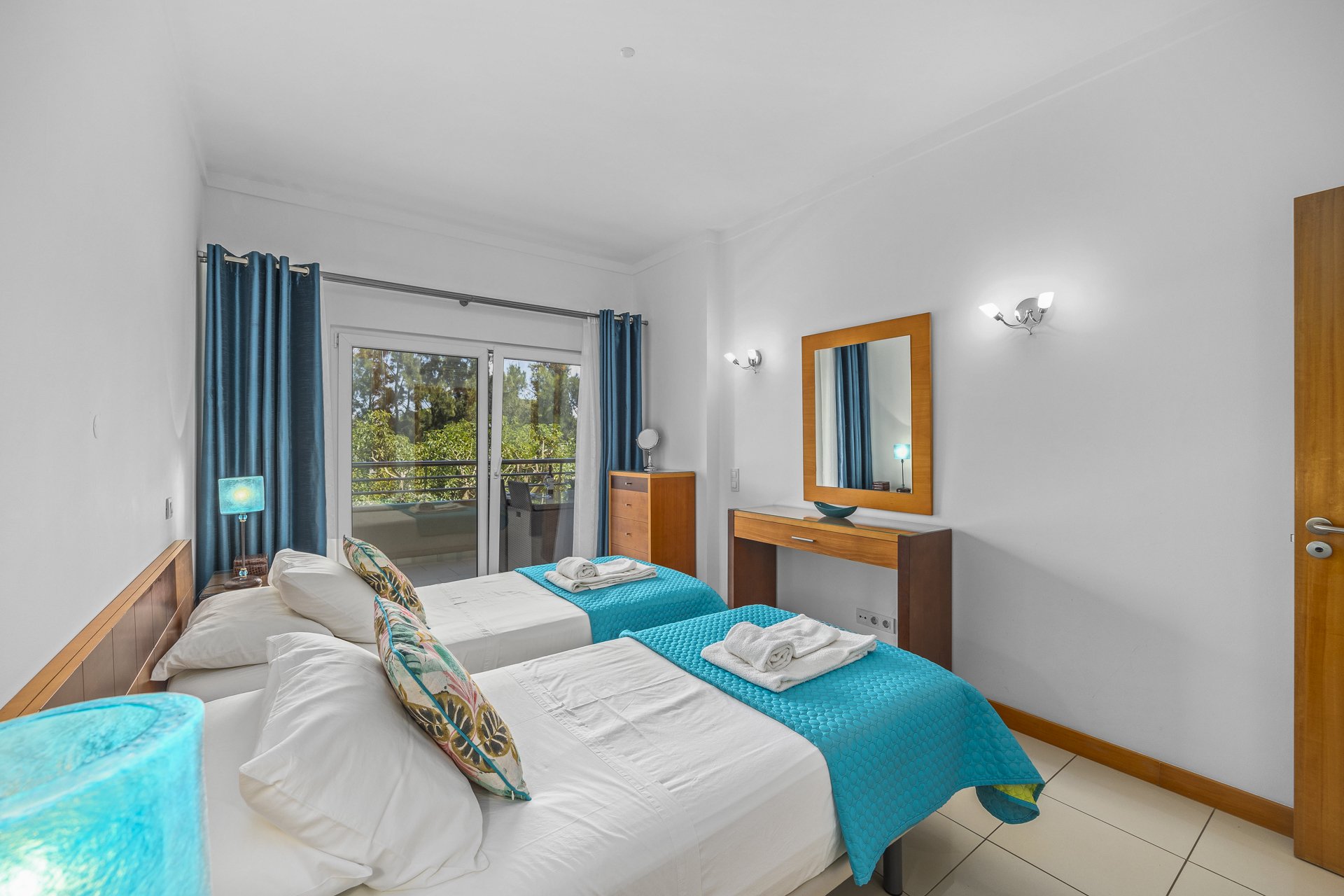 Twin bedroom with dressing table and balcony access