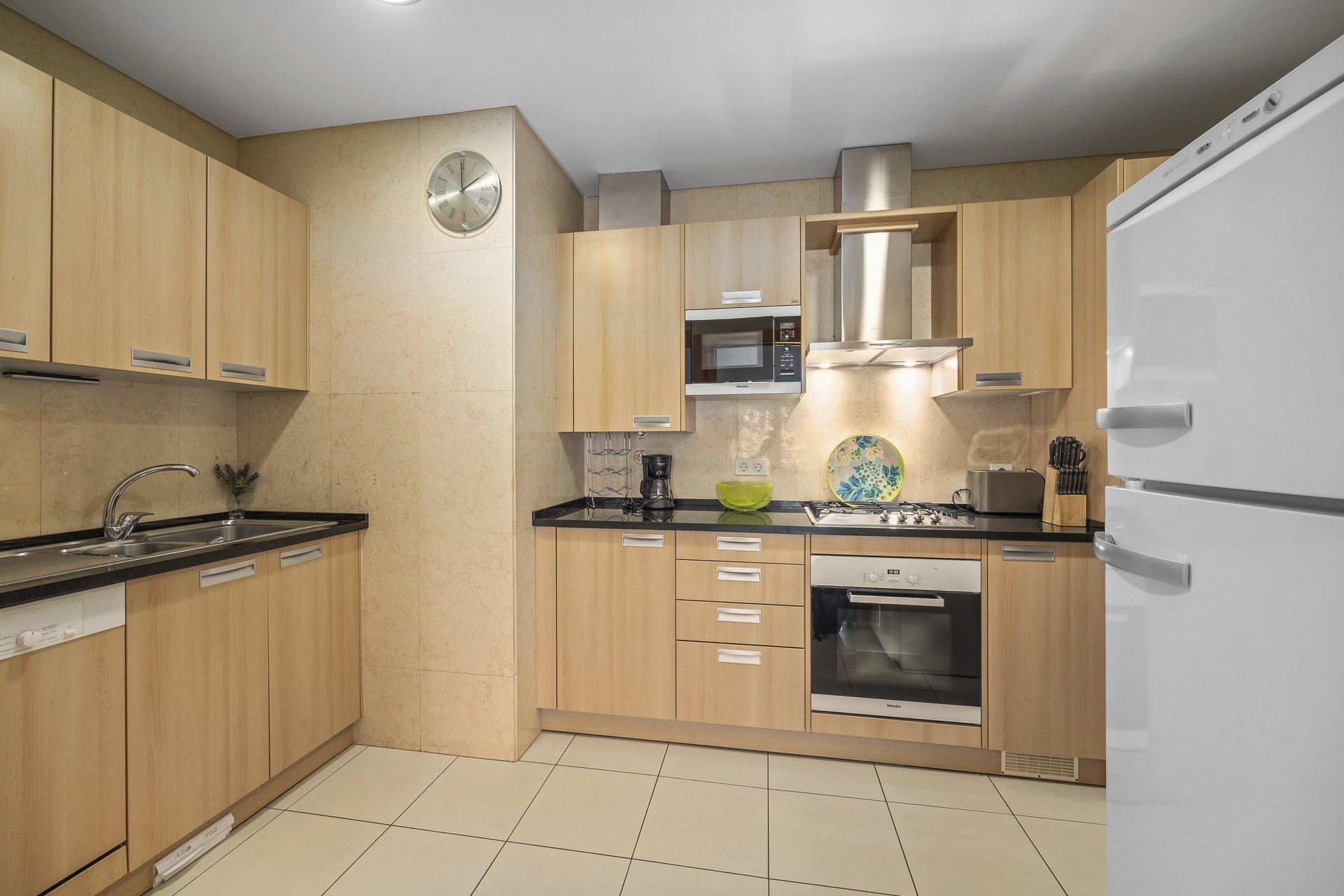 Kitchen with microwave, hood, and fridge-freezer