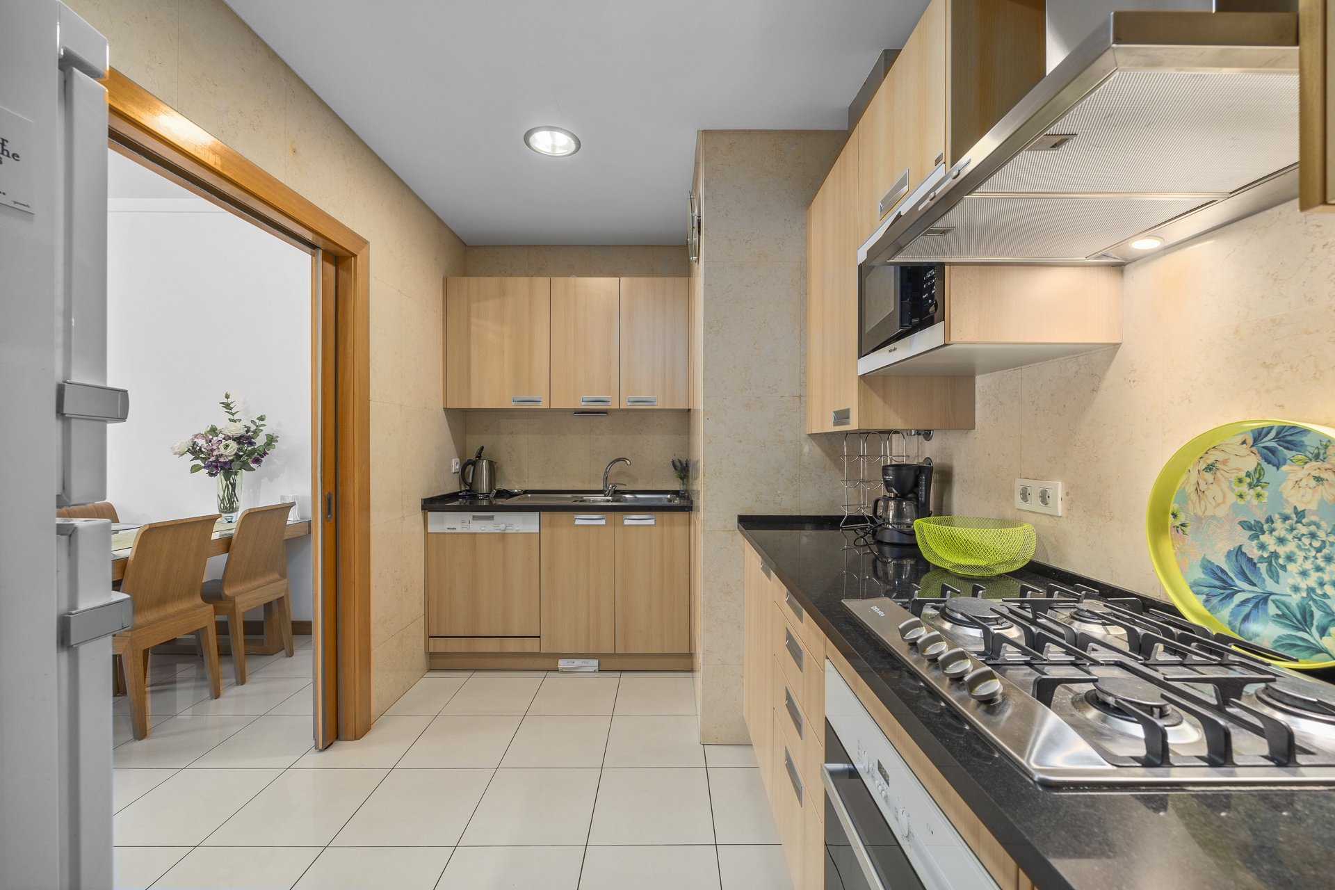 Kitchen with fridge-freezer and view through to the dining area