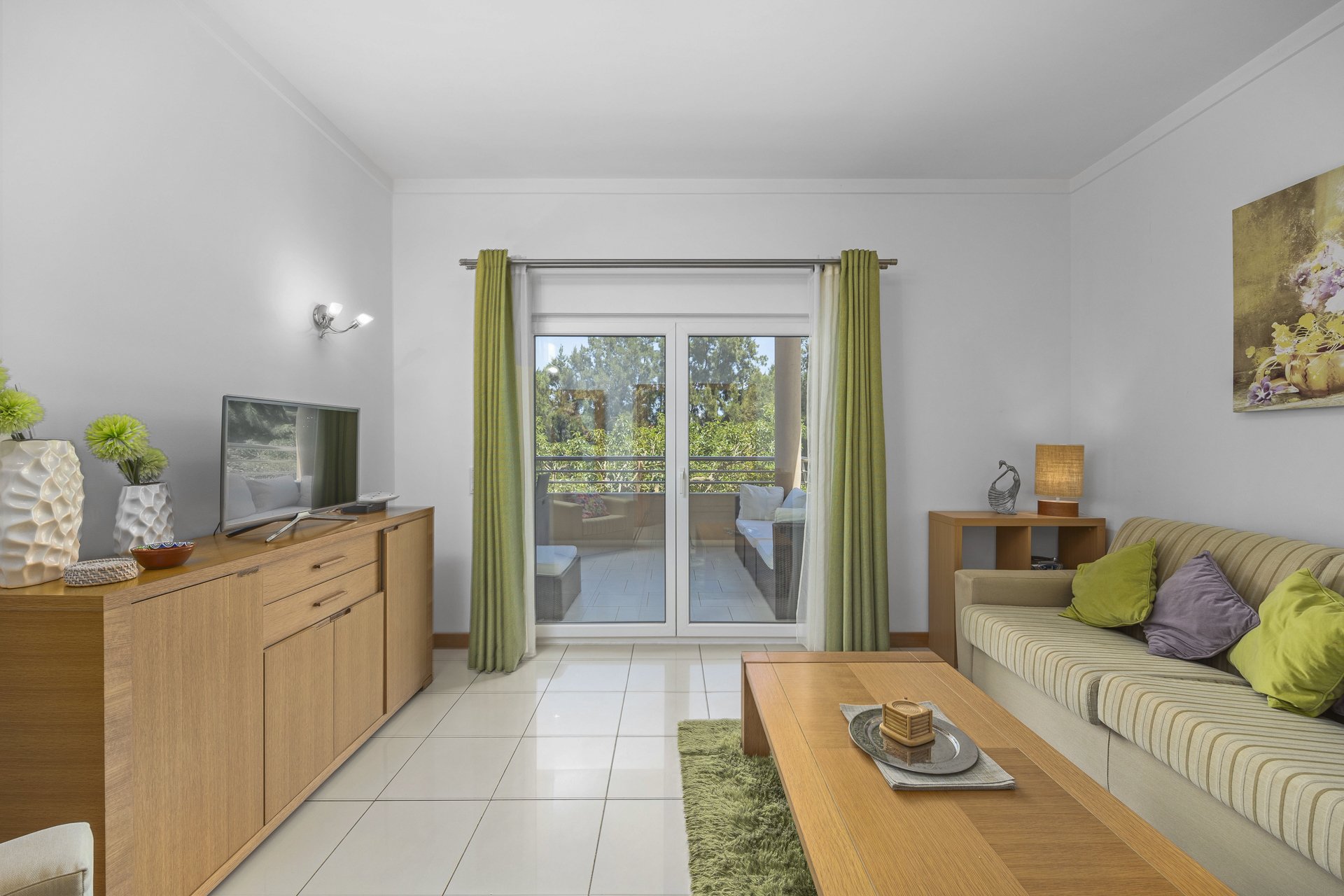 Living room with sideboard, TV, and balcony access