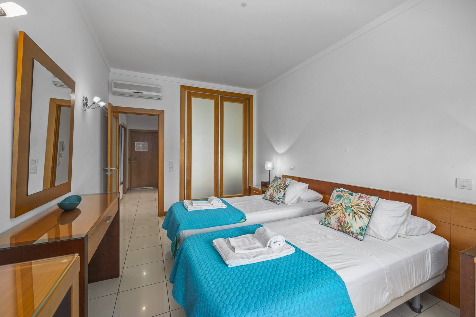 Twin bedroom with wardrobe and hallway access