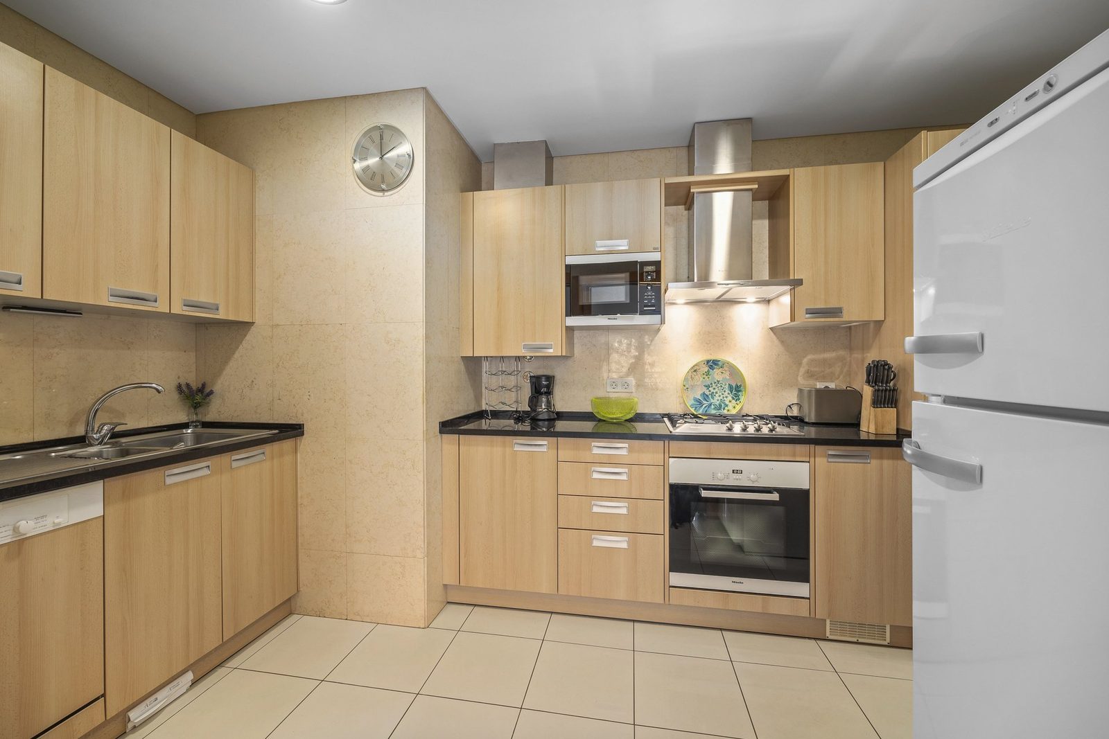 Kitchen with microwave, hood, and fridge-freezer