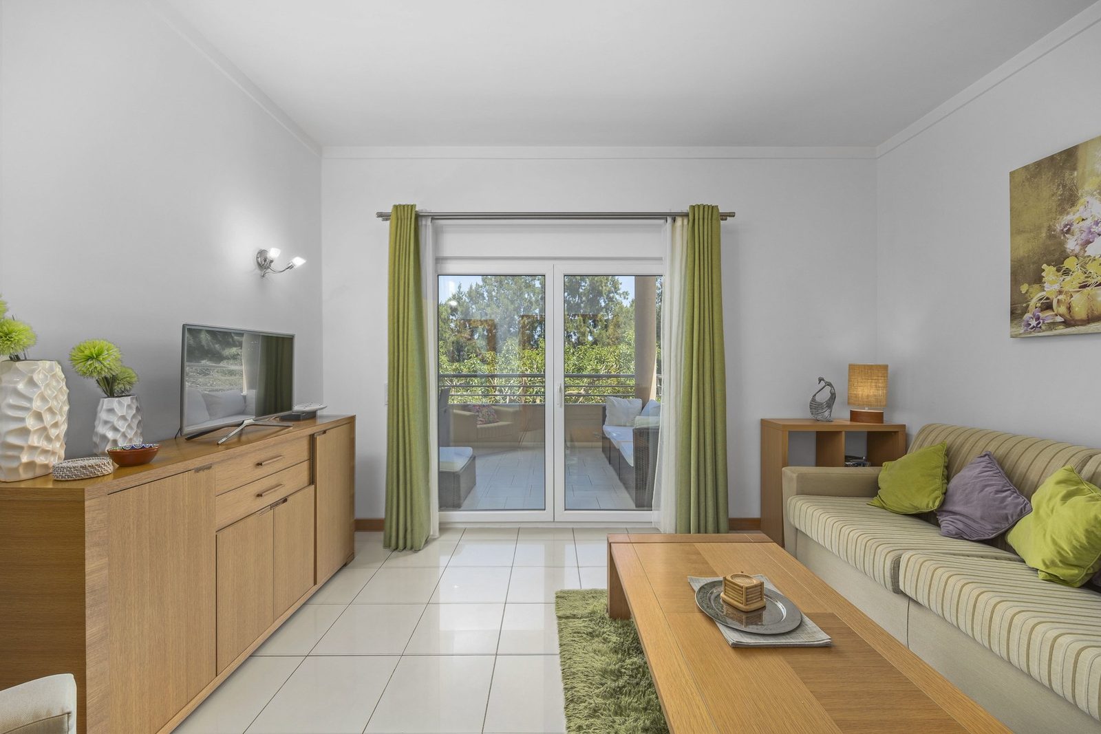 Living room with sideboard, TV, and balcony access