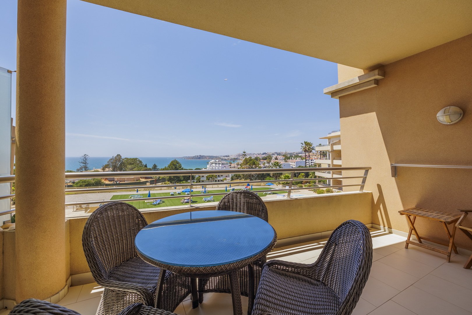 Balcony dining table with wide sea and coastline view