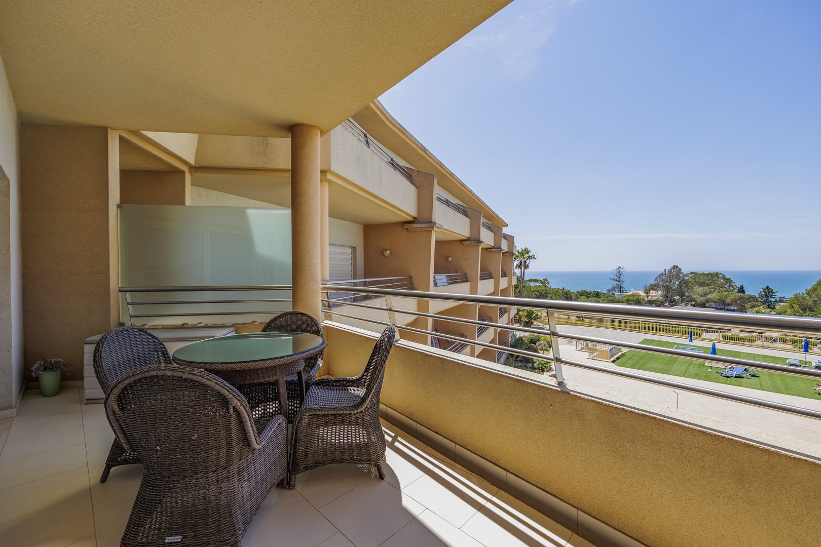 Balcony dining table with sea view and building alongside