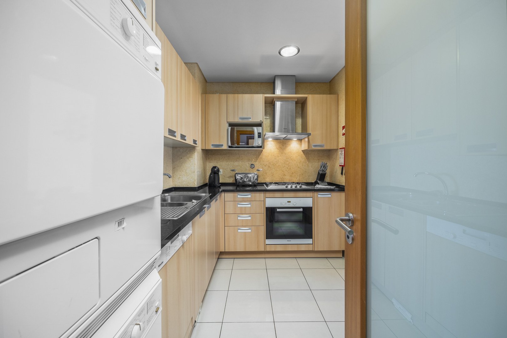 Kitchen with cabinets, oven, and hob