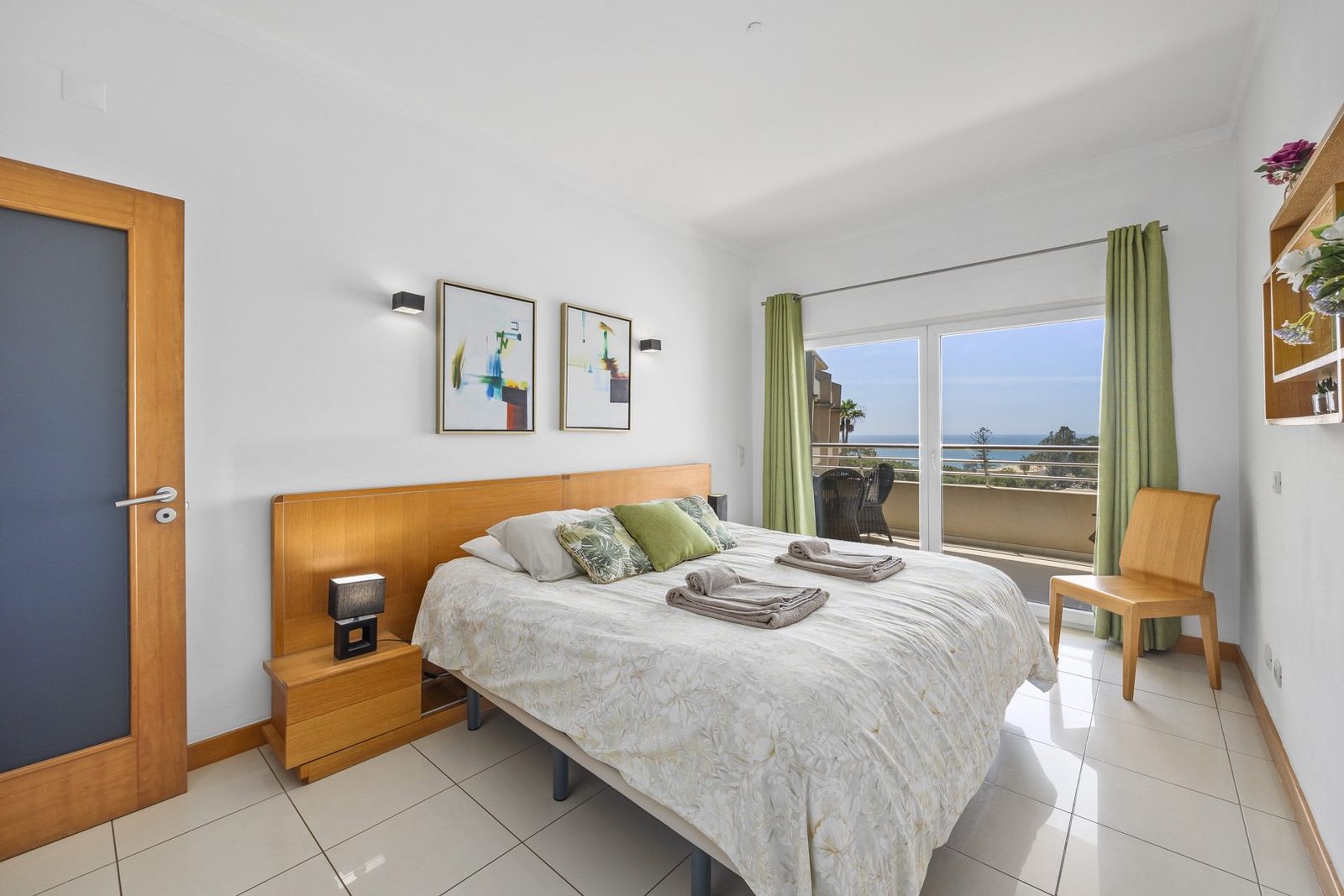 Bedroom with double bed, wall art, and balcony access