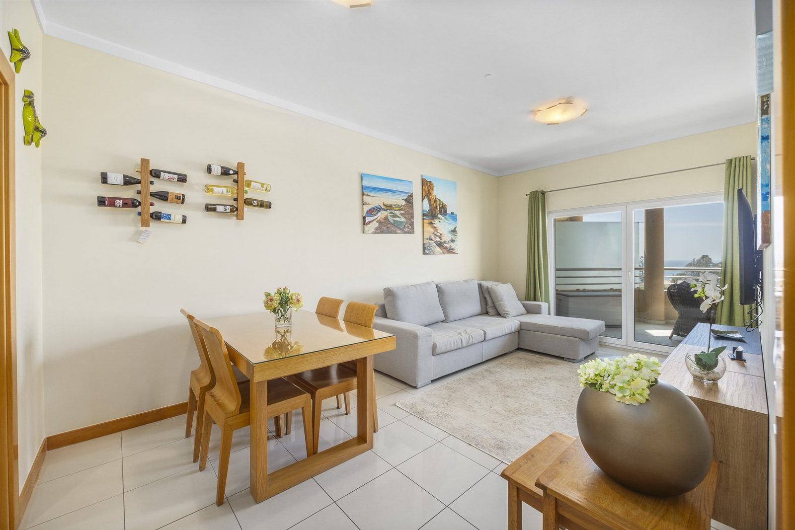 Living and dining area with sofa, wine rack, and sea view