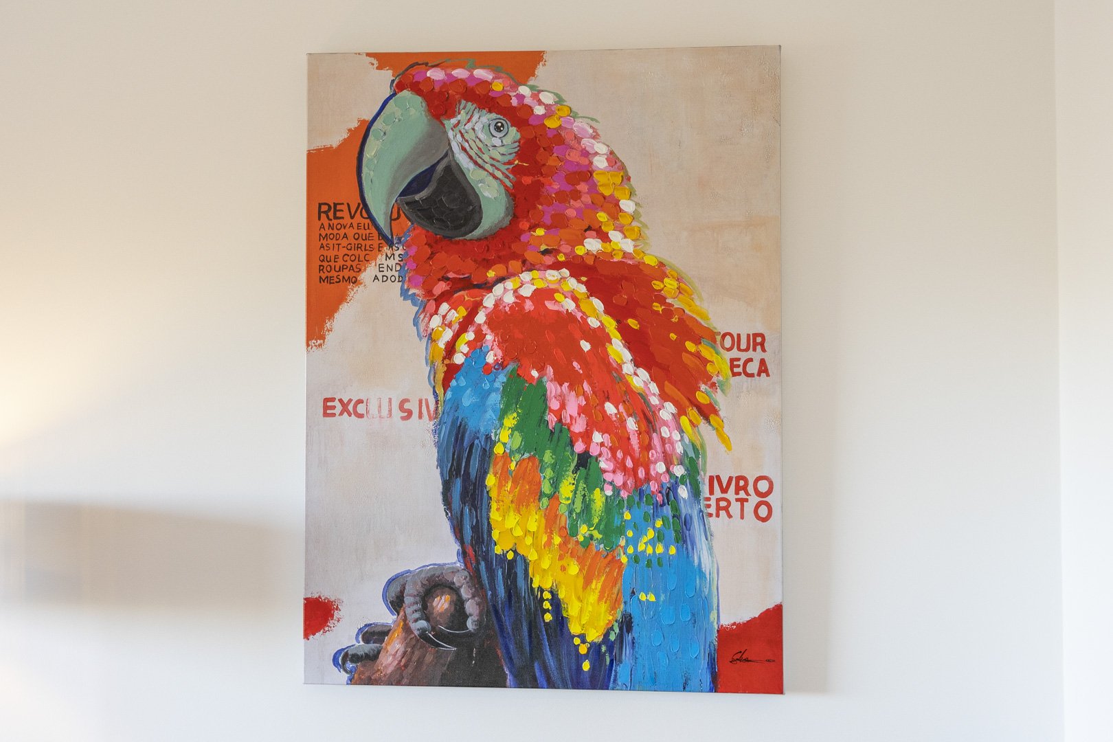 Colorful parrot artwork displayed in the apartment