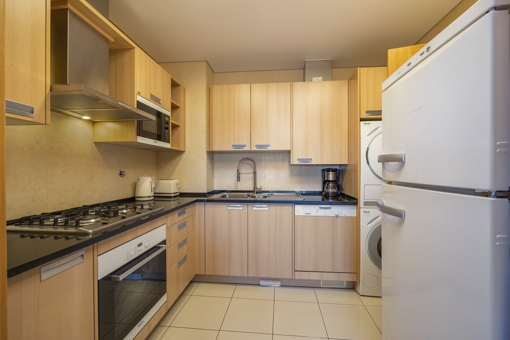 Kitchen with oven, hob, and fridge-freezer