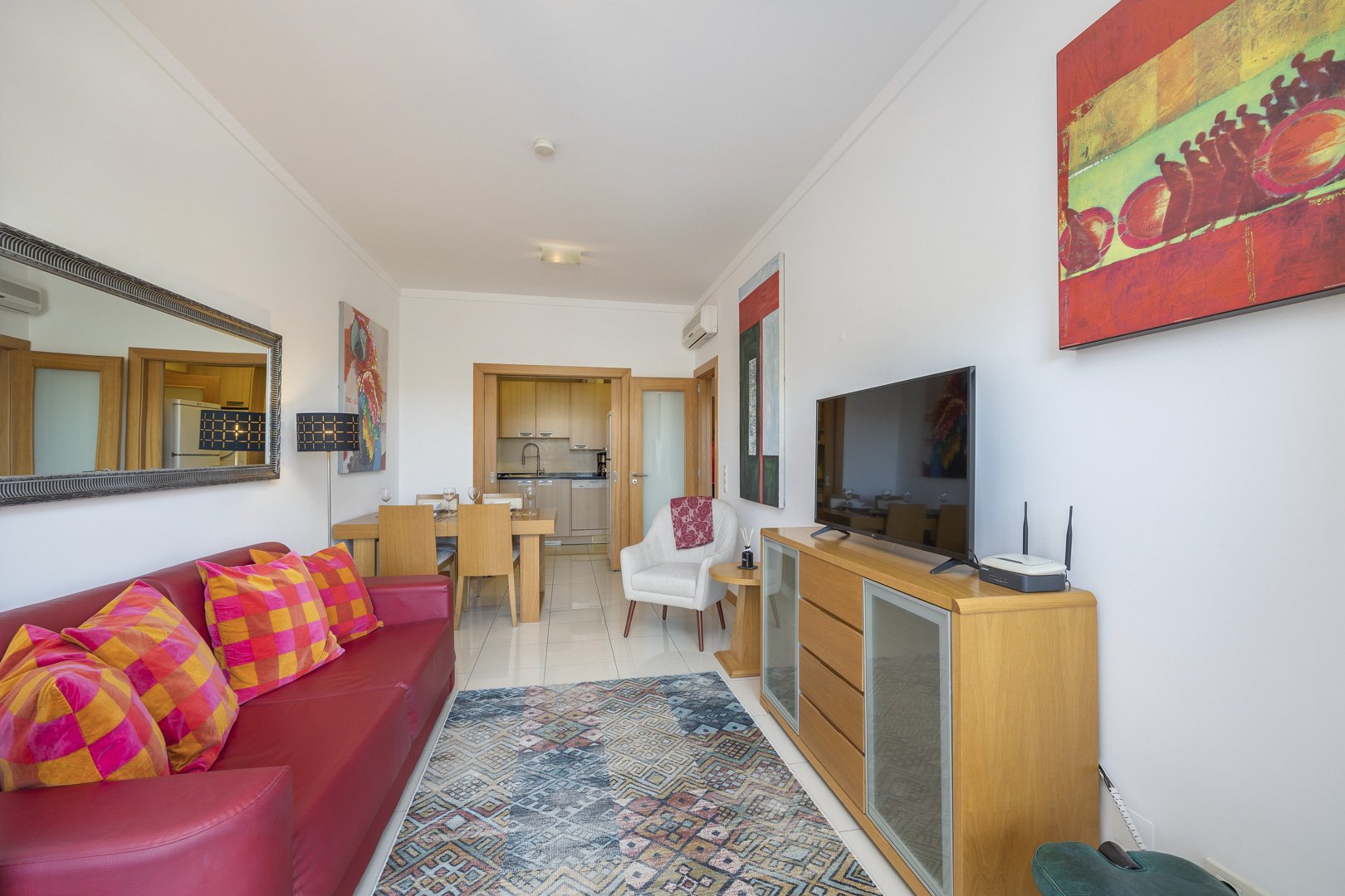 Living and dining area with sofa, dining table, and hallway view
