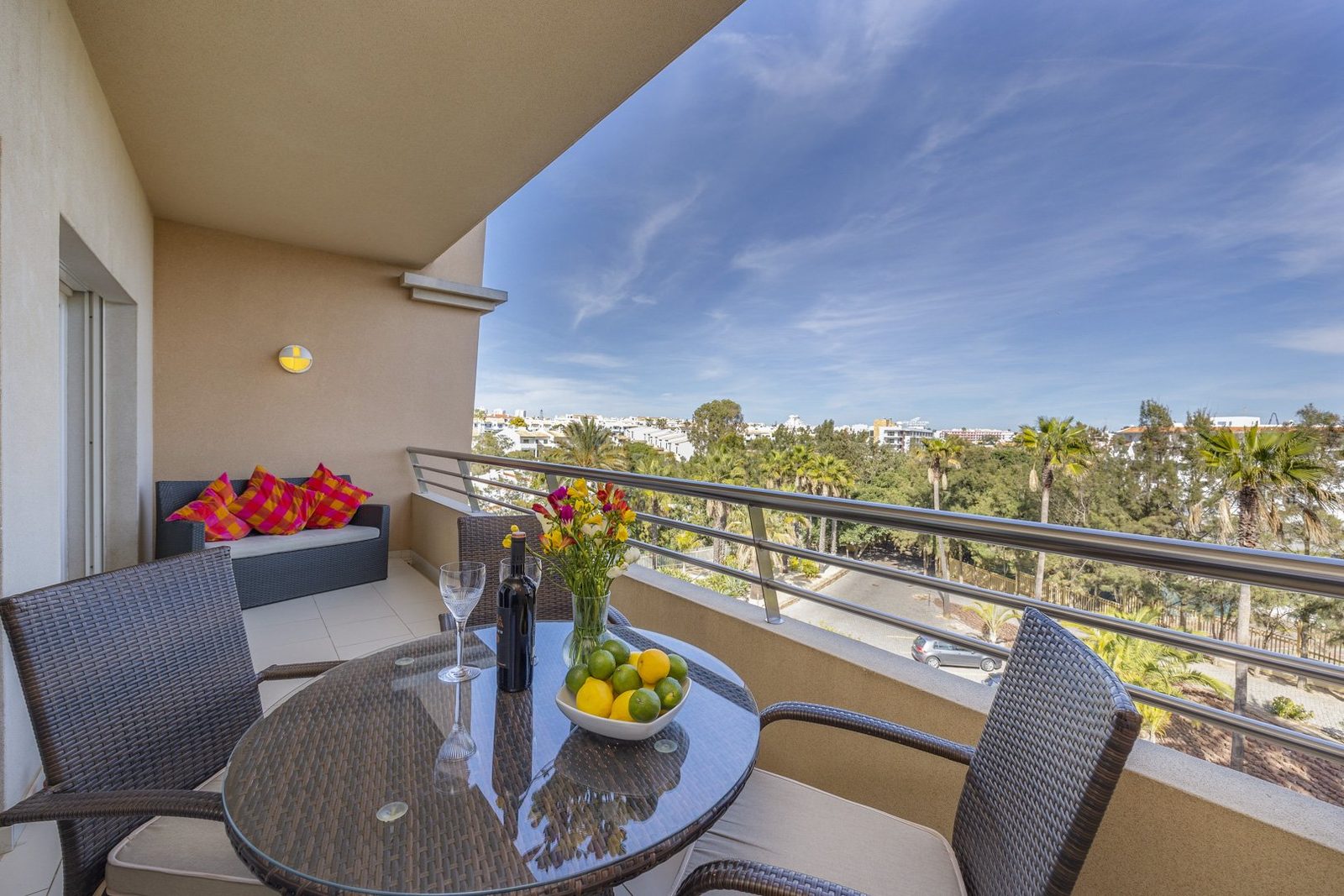 Balcony seating and dining area with sofa, wide view over the grounds