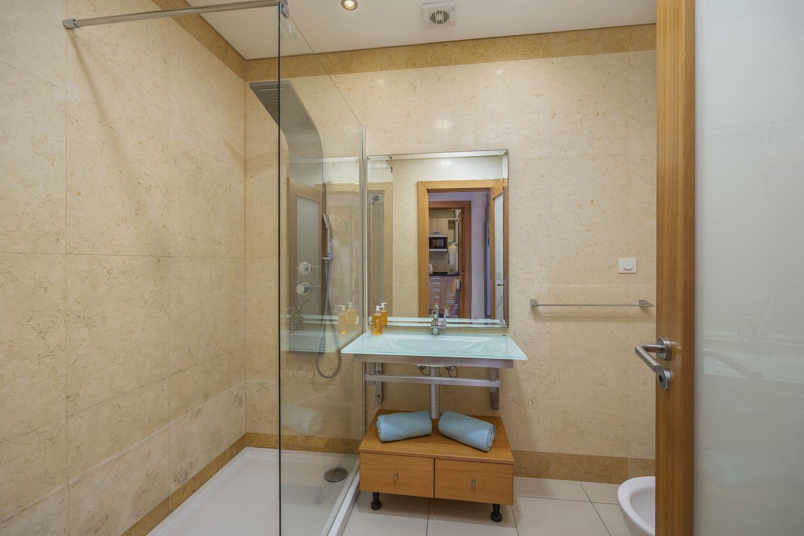 Bathroom with walk-in shower, sink, and bidet