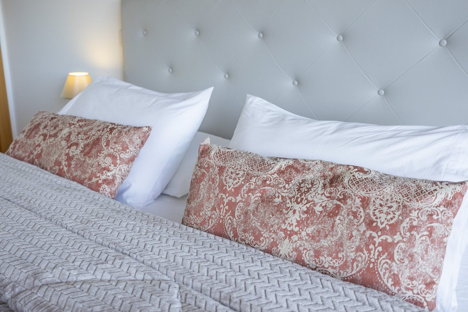 Bedroom detail with pillows on the double bed