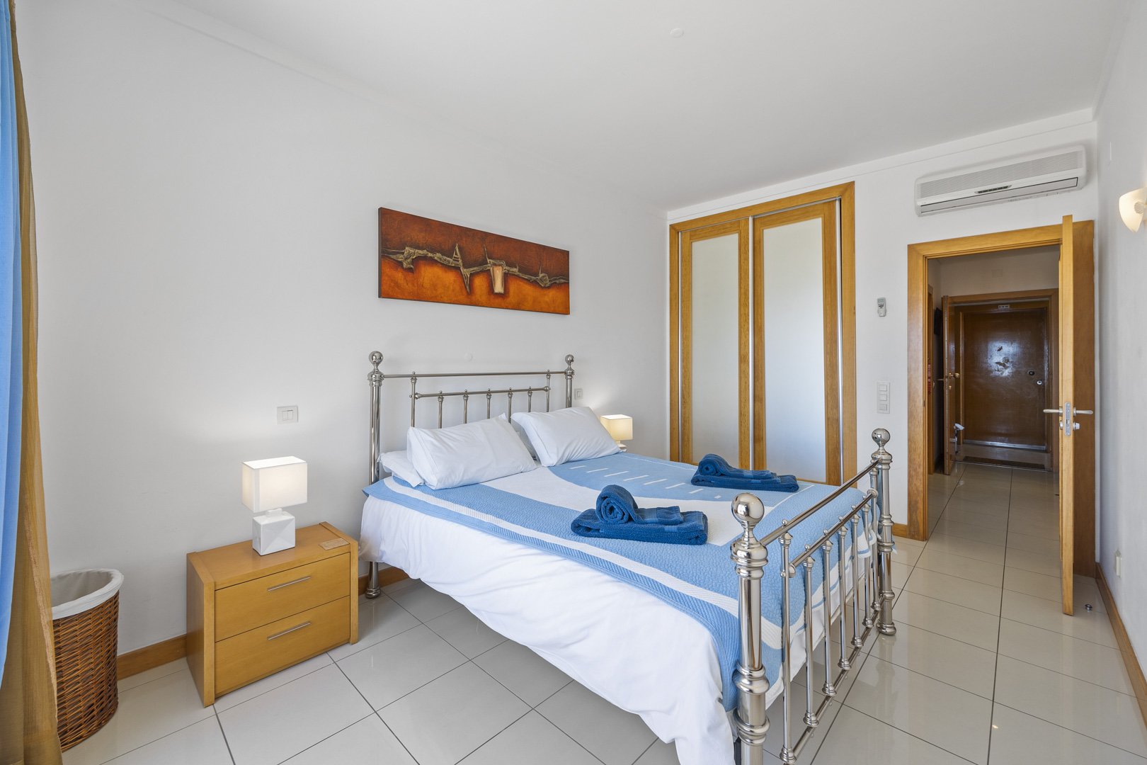 Bedroom with wrought iron bed and wardrobe