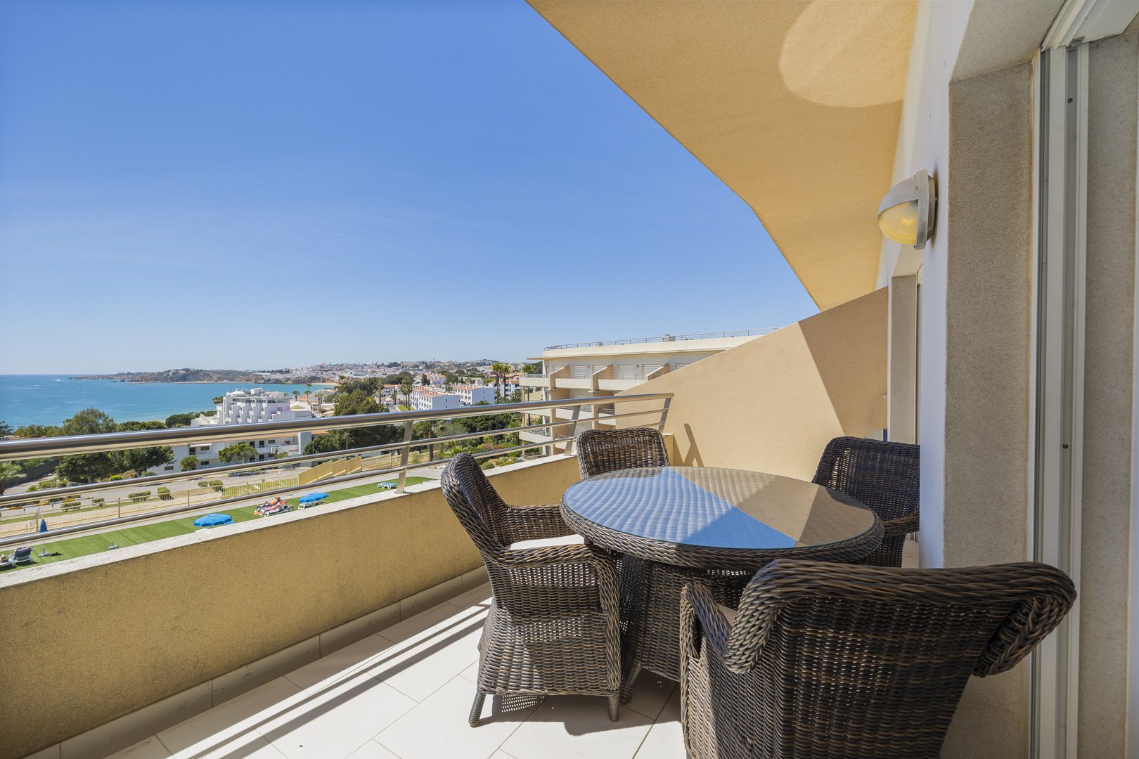 Living room with TV and open sliding doors to the balcony sea view