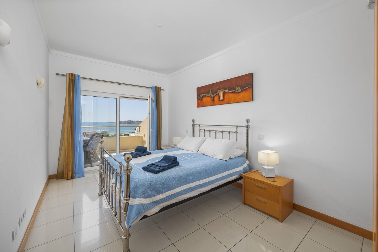 Bedroom with bed and sea view balcony access