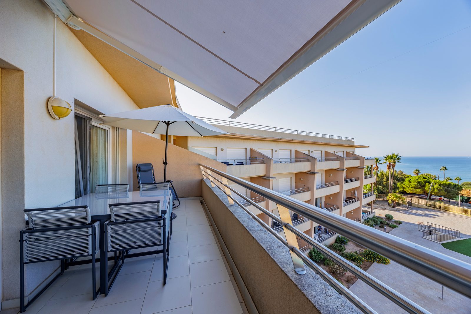 Balcony dining table and sun lounger under the awning