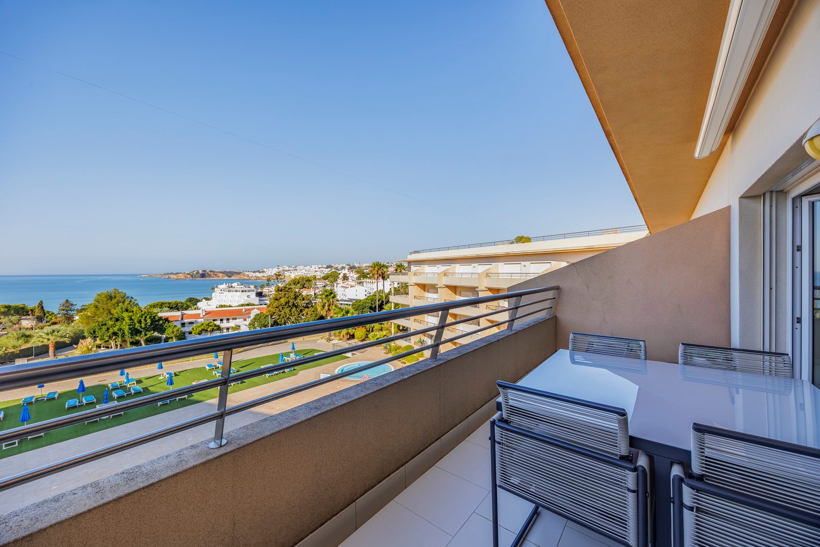 Balcony table with a view over the pool gardens to Albufeira