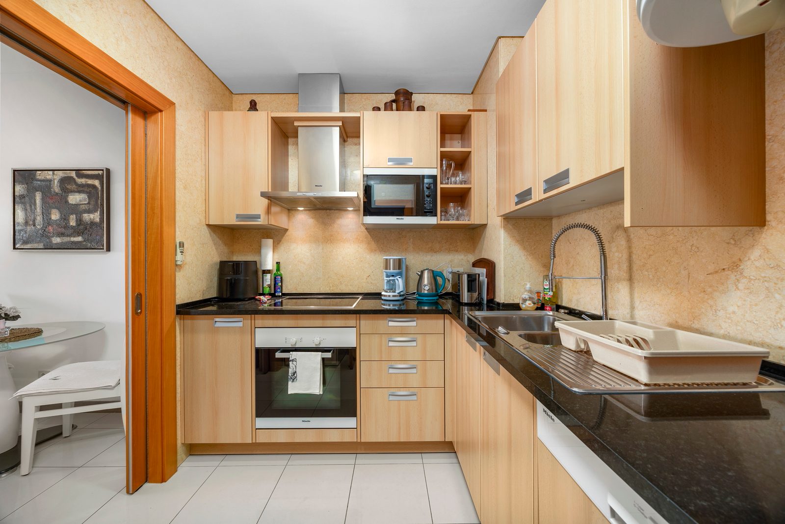 Kitchen with oven, hob, microwave, and dishwasher