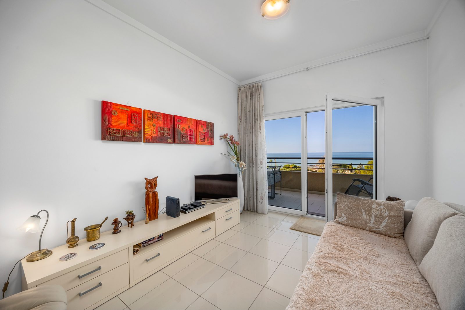 Living room TV unit and balcony doors with sea view