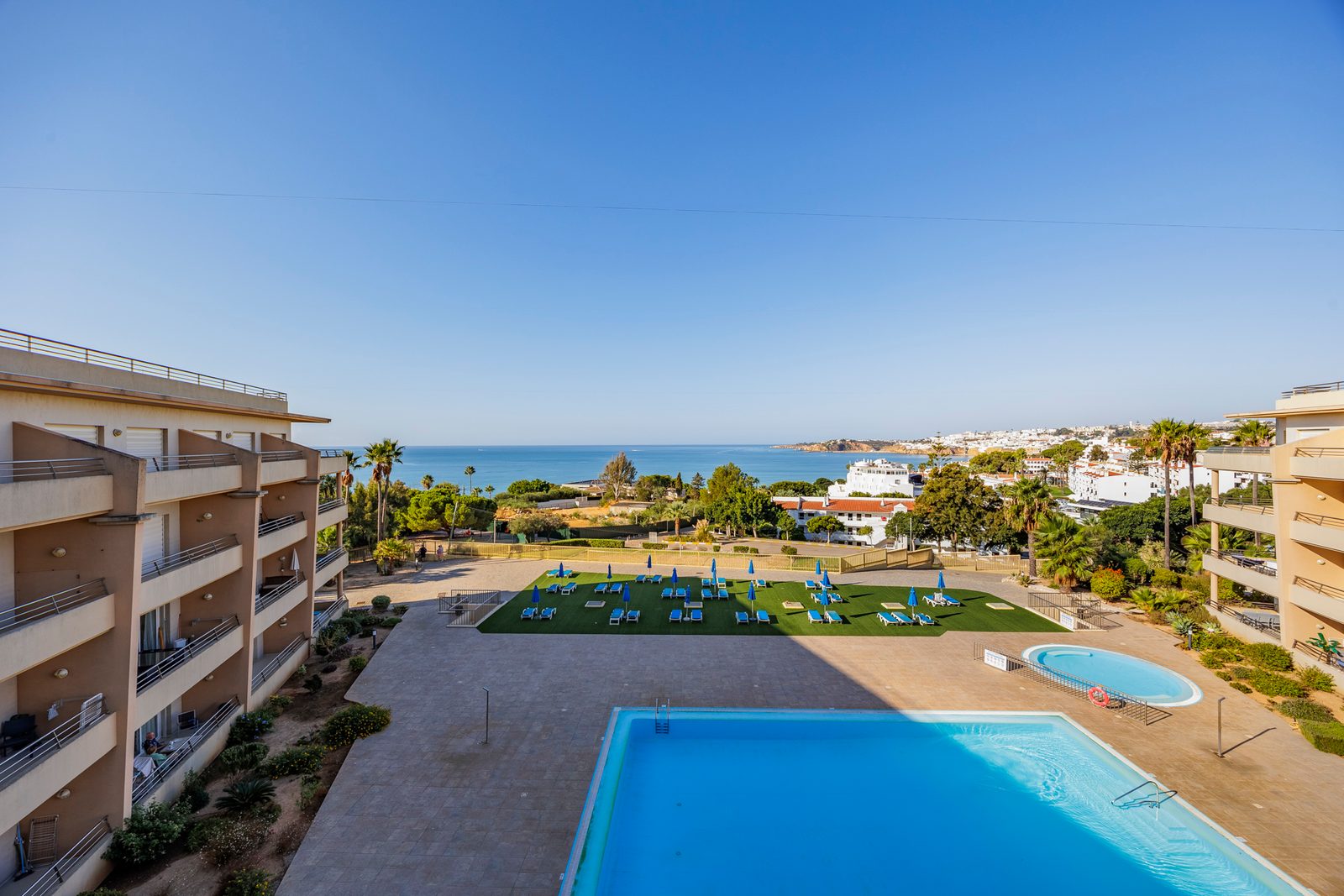 View from the balcony over the pool and gardens to the sea and Albufeira