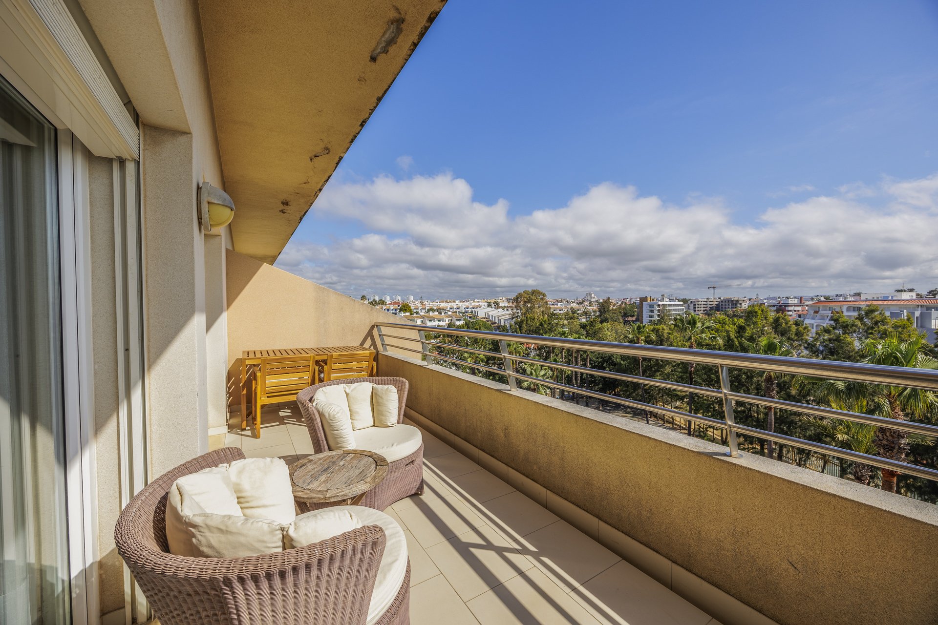 Balcony with rattan chairs and view over the town