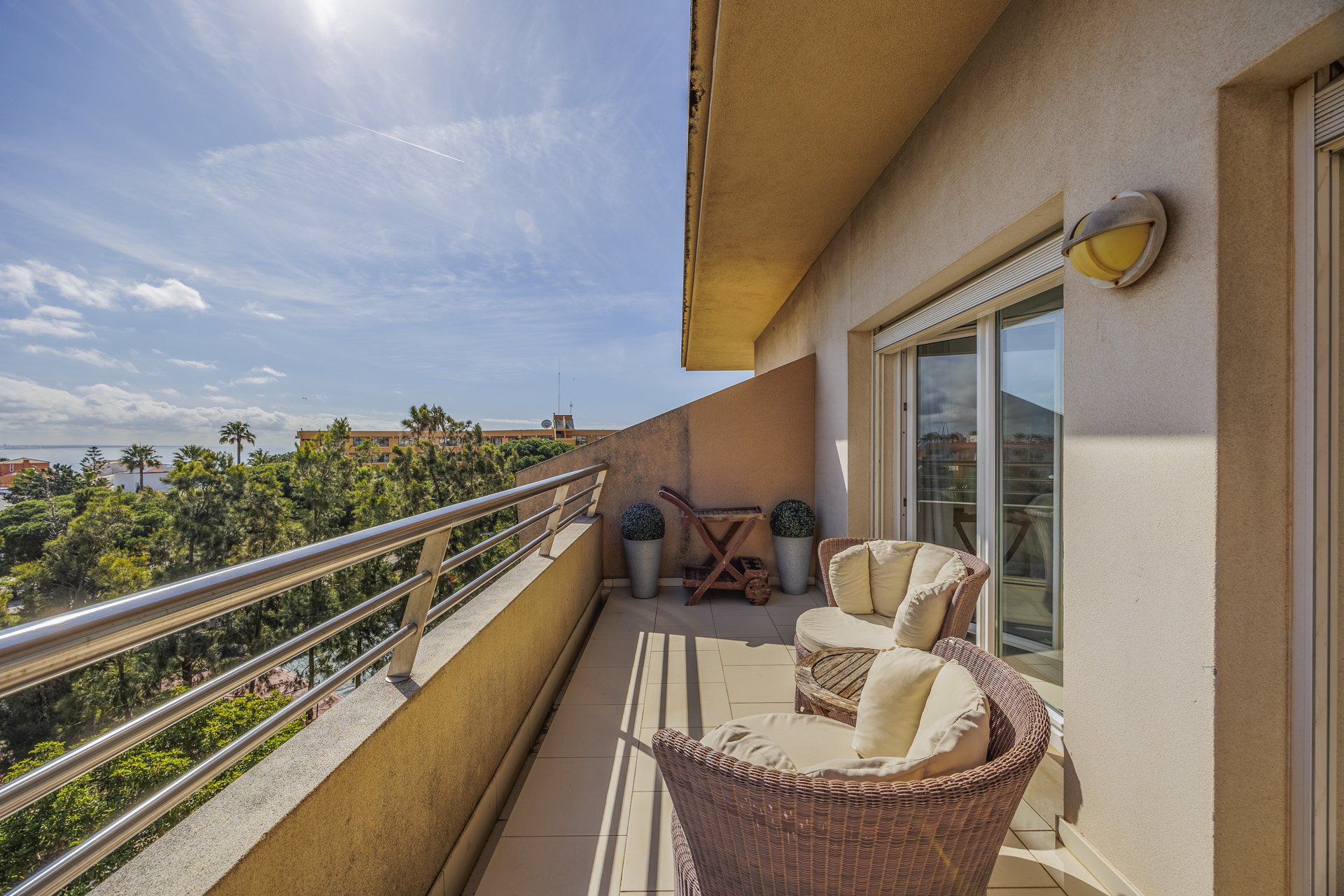 Balcony with rattan chairs and a wide sea view