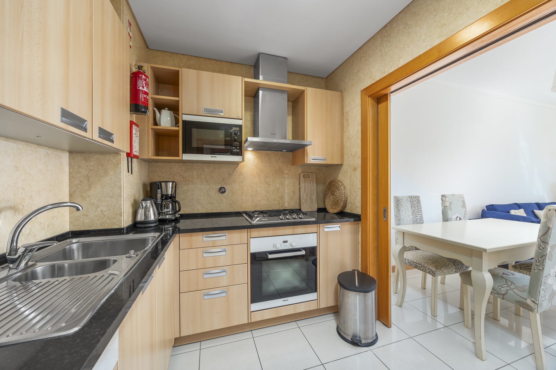 Kitchen with hob, oven, and dining area view