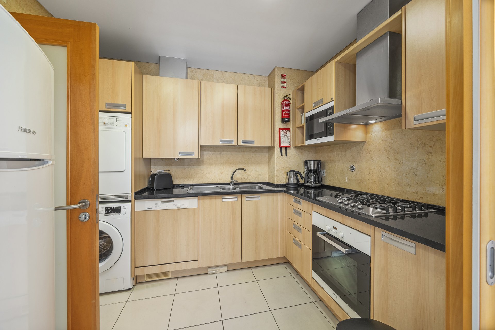Kitchen with fridge-freezer, hob, and oven