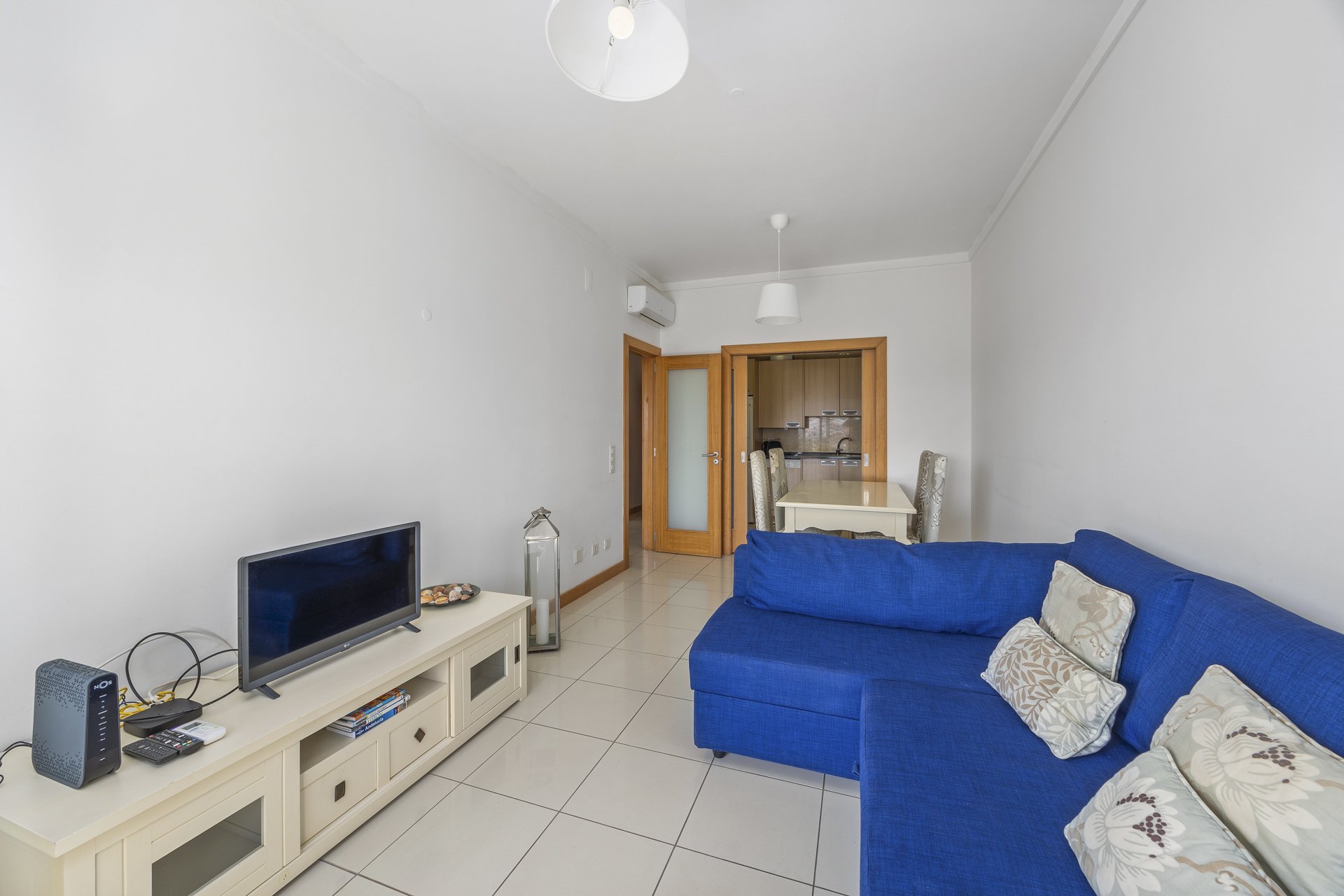 Living room with TV, sofa, and dining area view