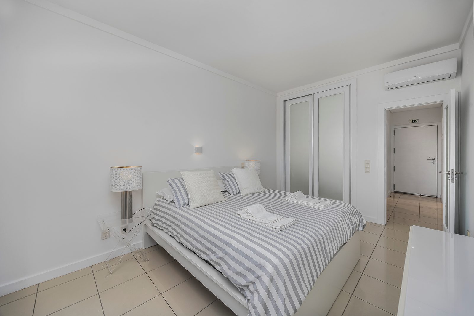 Bedroom with double bed, built-in wardrobe, and air conditioning