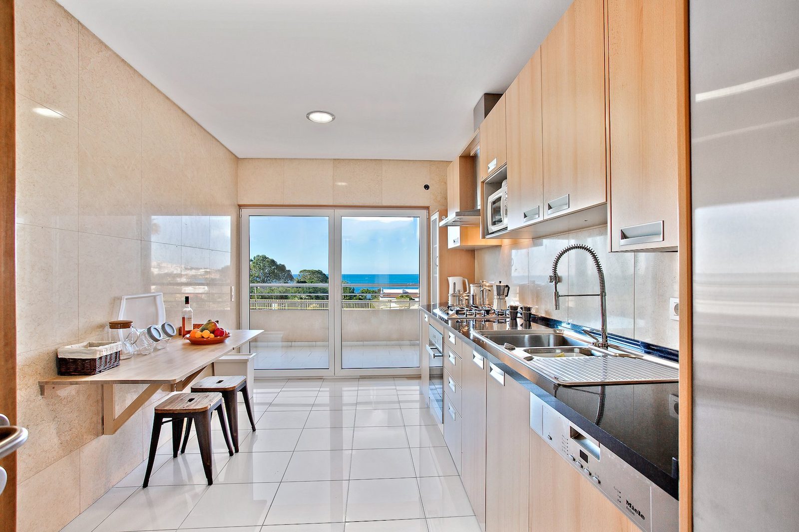 Kitchen with breakfast bar, sea view, and stainless steel appliances