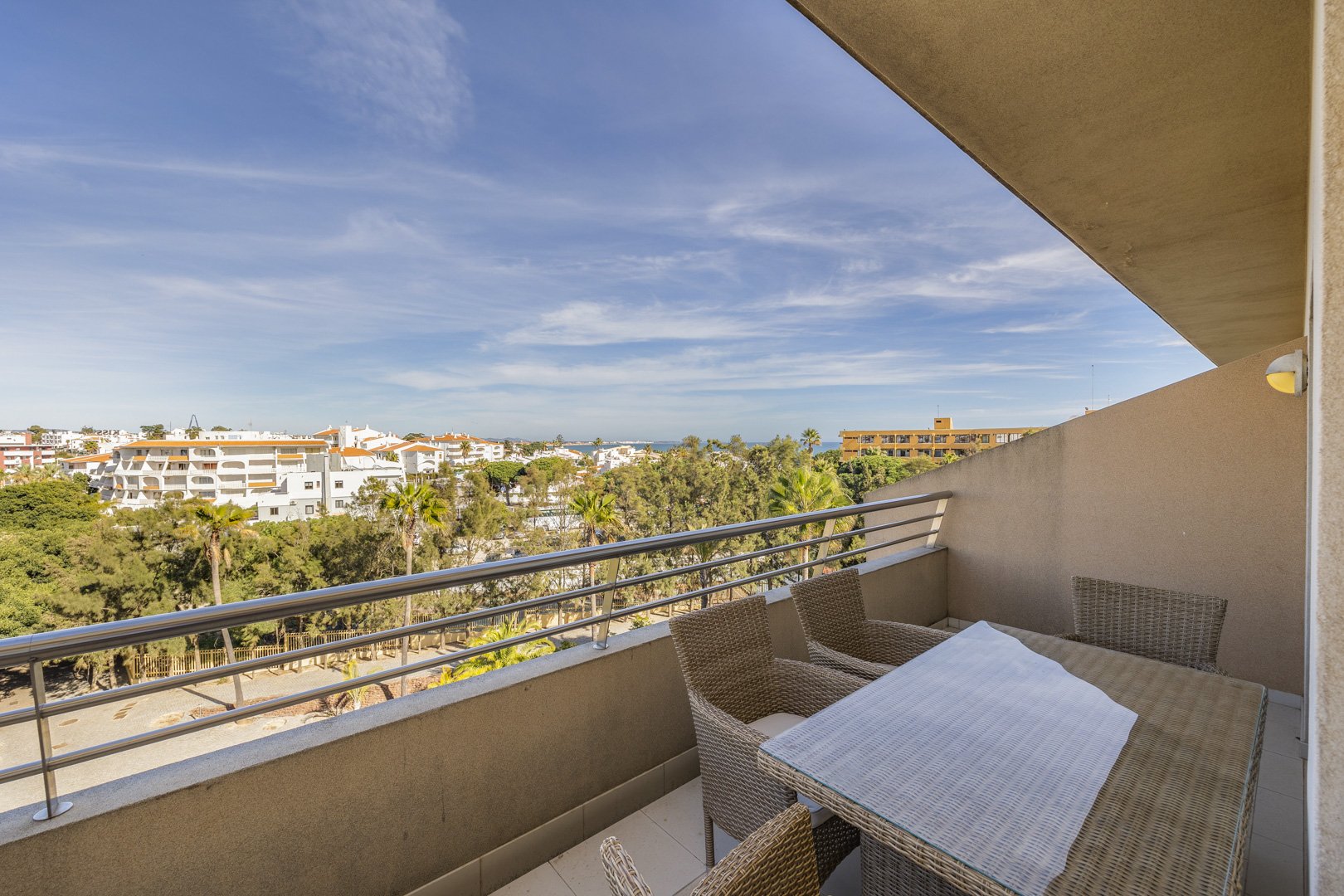 Balcony dining table and chairs with elevated town view