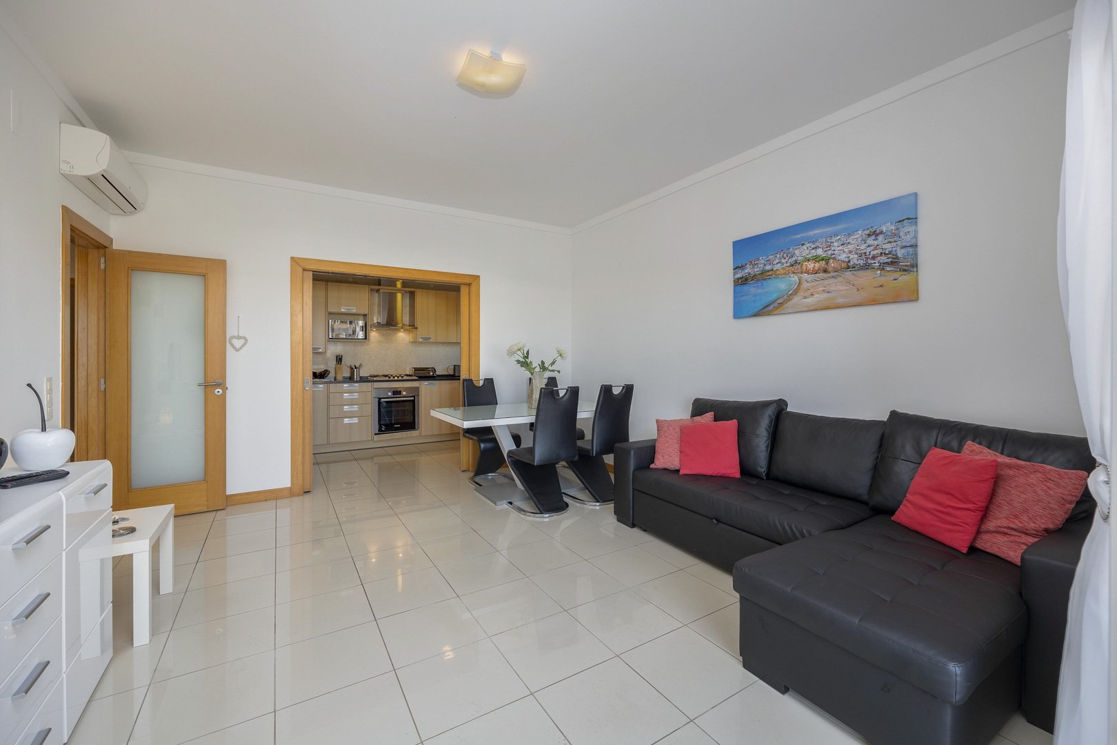 Living room with sofa and view through to the kitchen and dining area