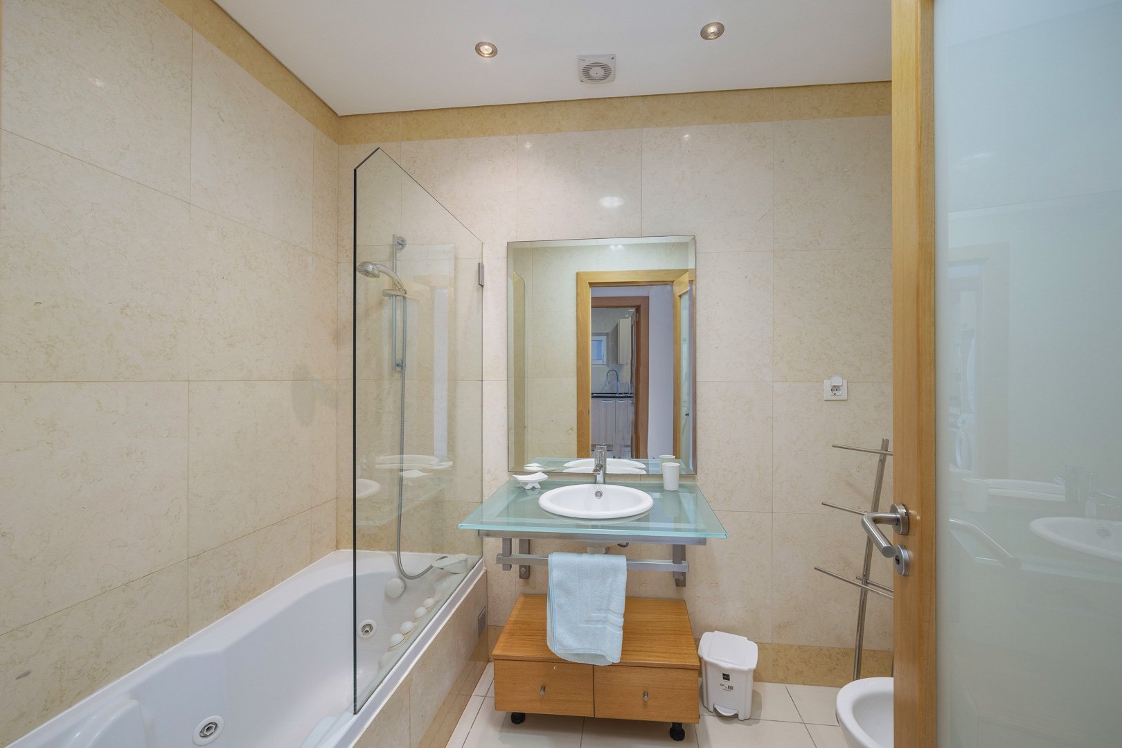 Bathroom with bathtub, shower screen, and bidet