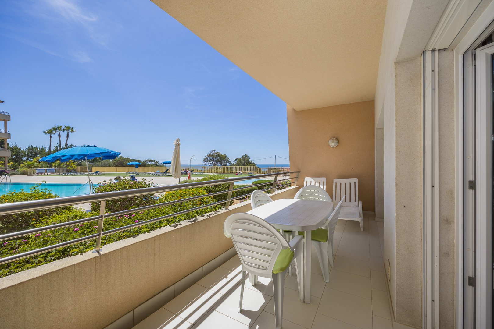 Balcony with dining table, chairs, and pool view
