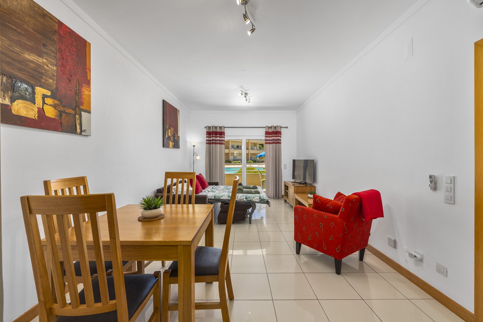 Dining area with view through to the living room and pool-view balcony