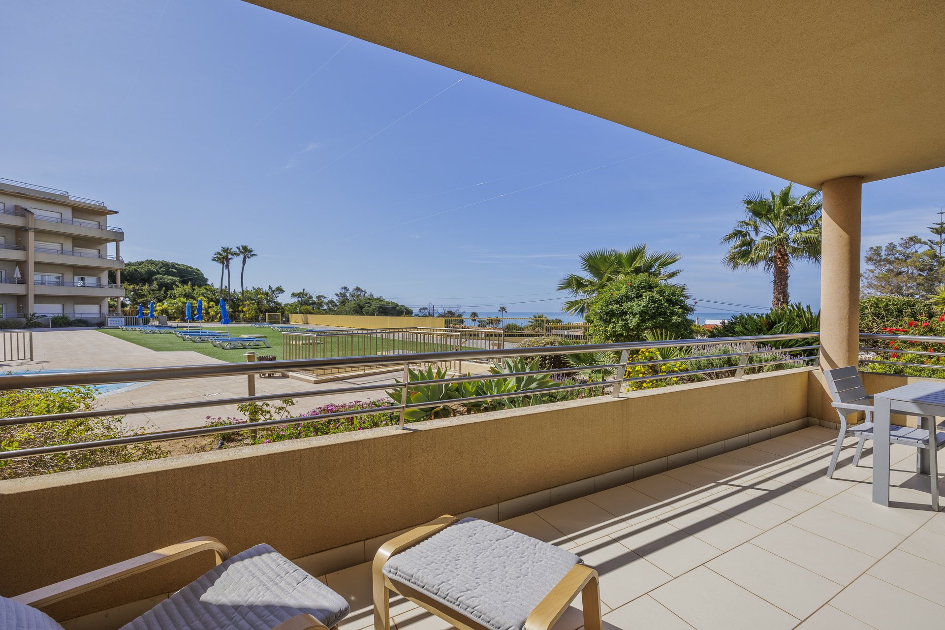 Balcony with table, chairs, and sea view