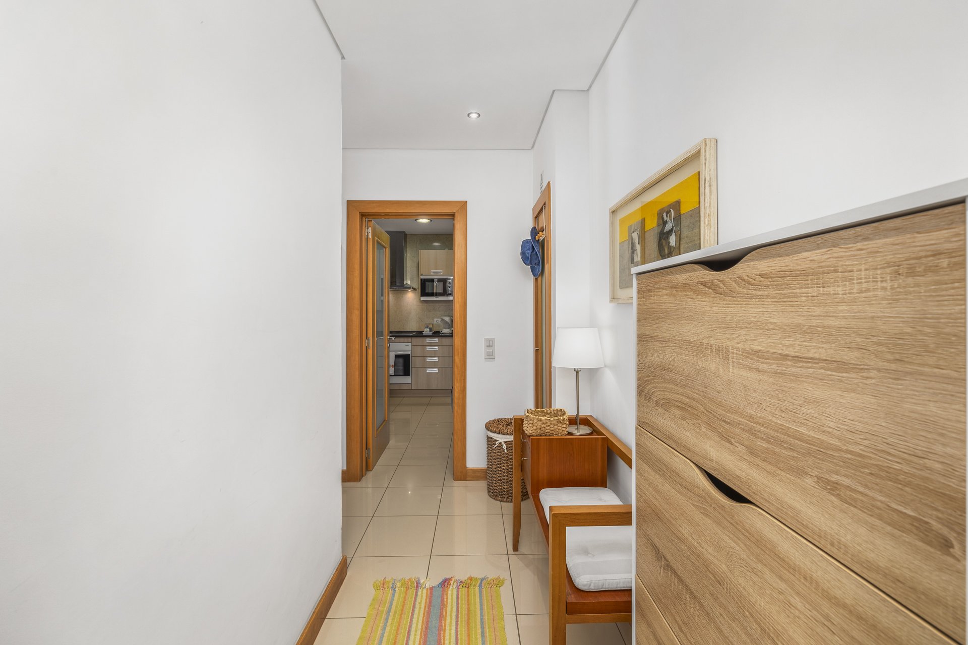 Entrance hallway with cabinet and view through to the kitchen