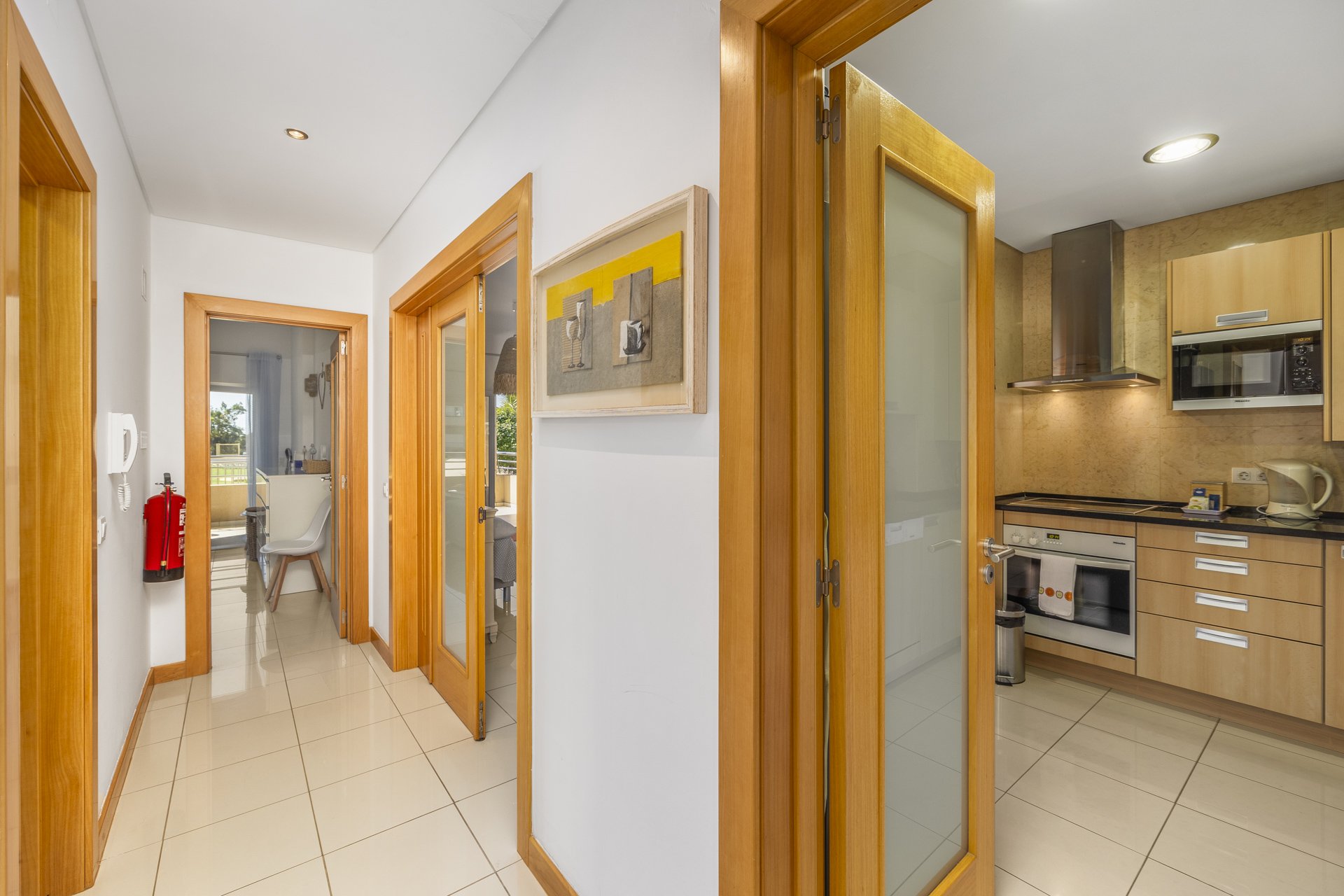 Hallway with doors leading to the bedroom and kitchen