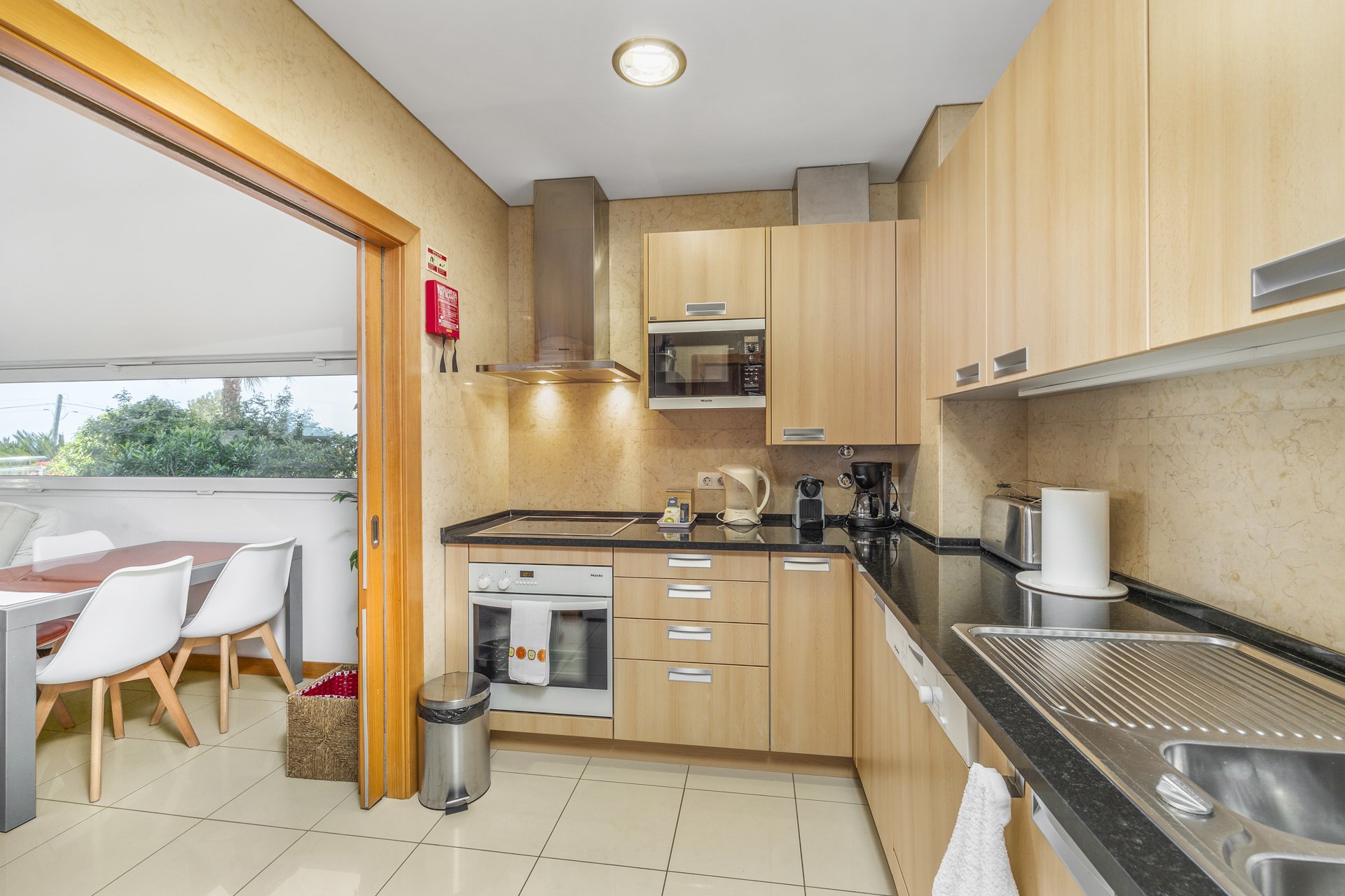 Kitchen with view through to the balcony dining area