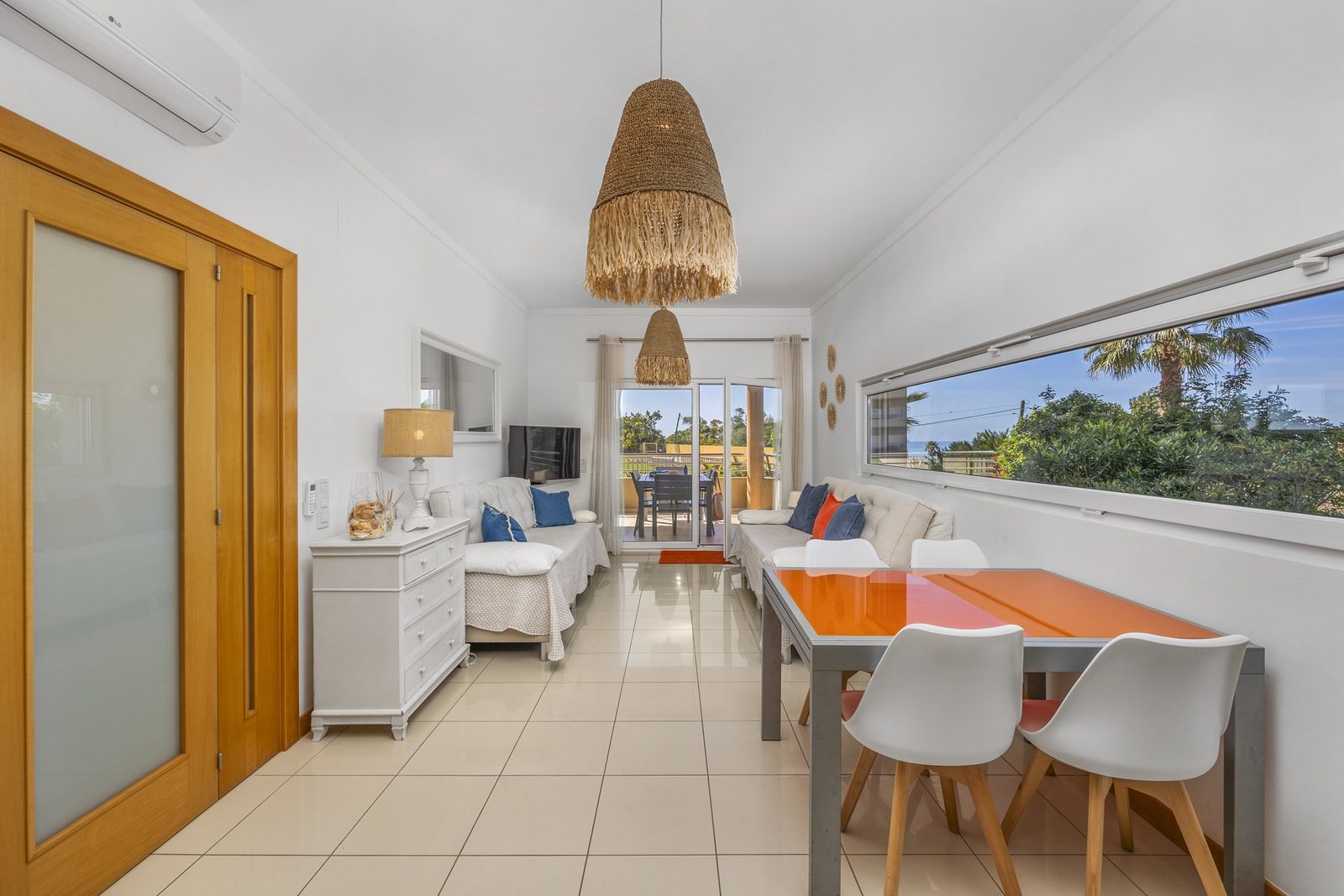 Dining area with view through to the living room and balcony