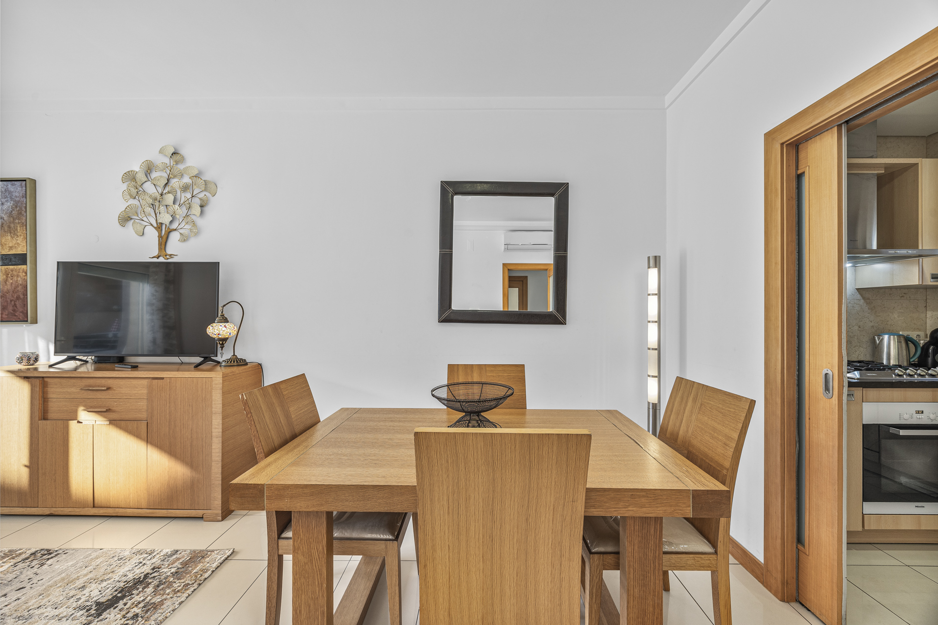 Dining area with table for six and a view through to the kitchen