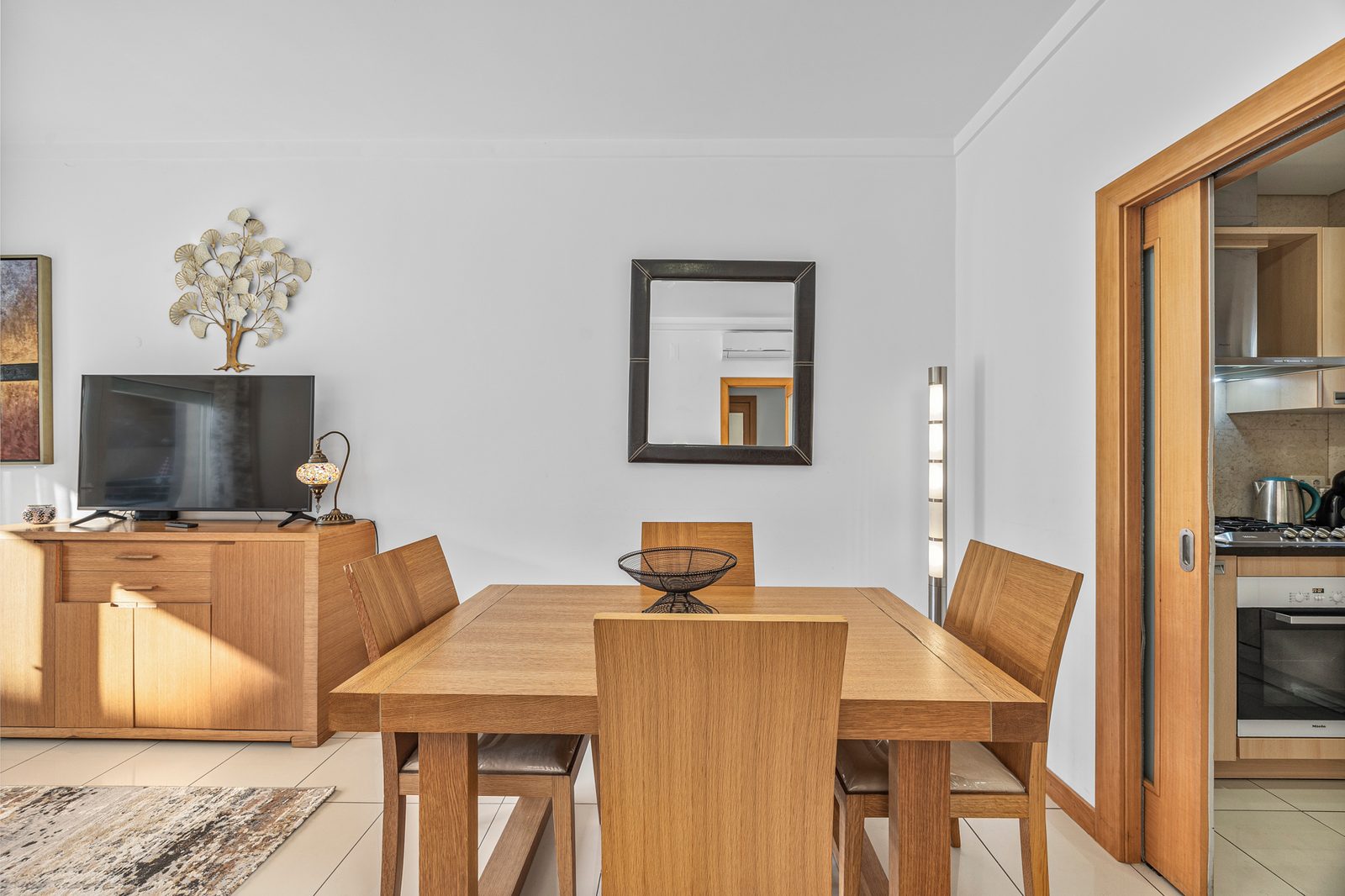 Dining area with table for six and a view through to the kitchen