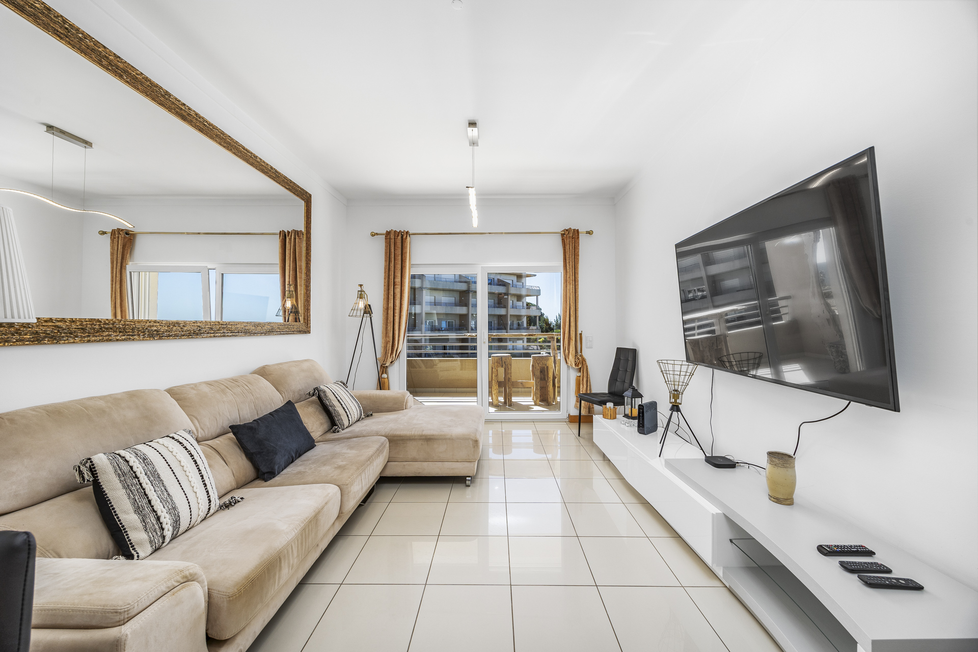 Living room with corner sofa and wall-mounted TV
