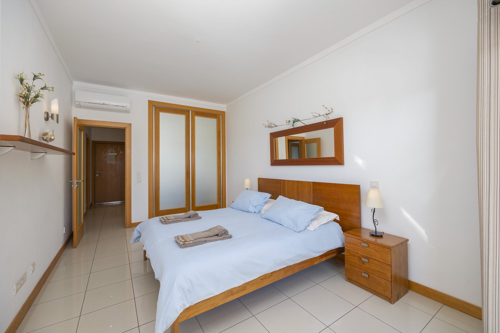 Bedroom with wardrobe and view through to the hallway