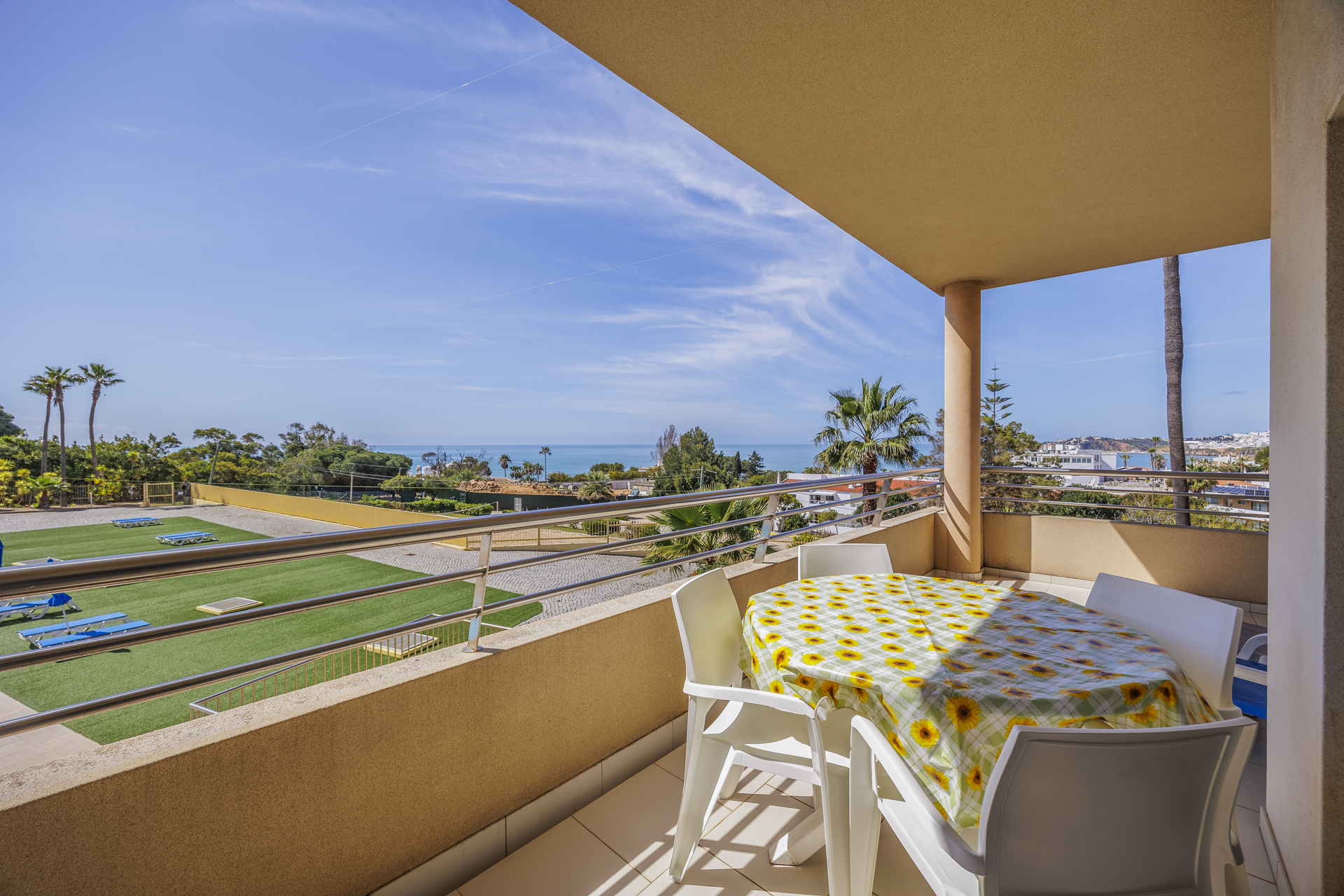 Balcony with dining table, chairs, and sea view